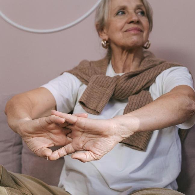 Mujer haciendo ejercicios de estiramientos en casa.