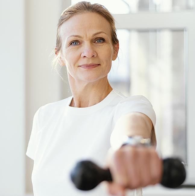 Mujer haciendo ejercicio con mancuernas.