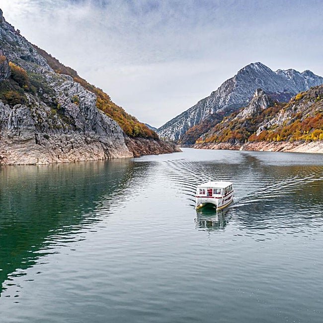 Un barco surcando los fiordos leoneses.